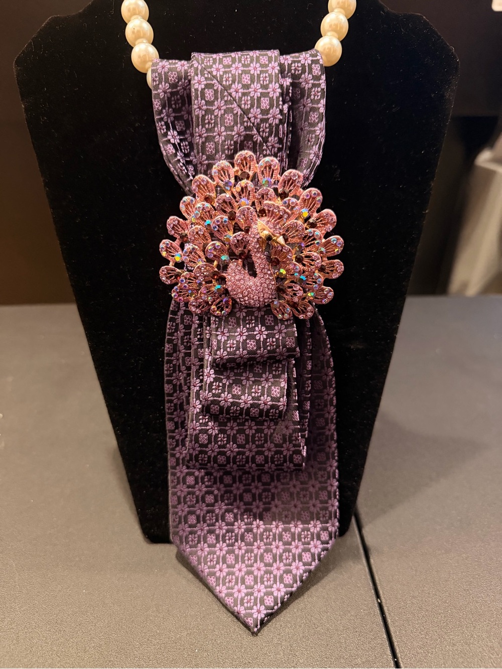 Purple Patterned Tie with Pink Peacock Brooch